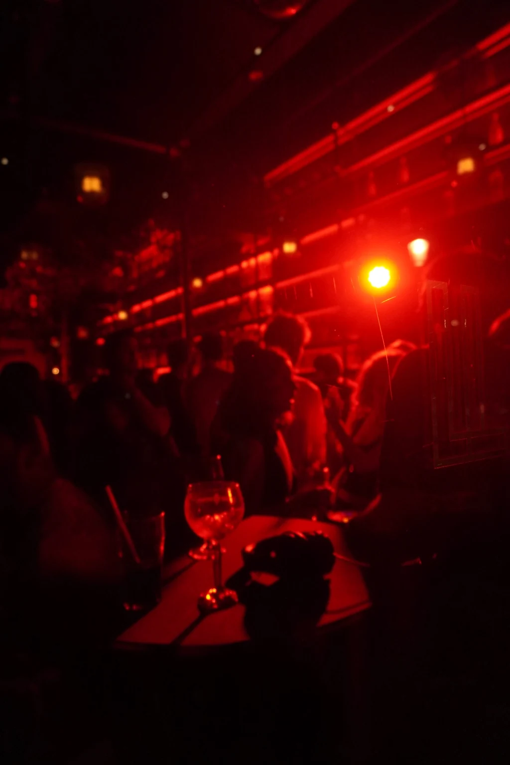 Red-lit crowd and bar at DELETE:TUR