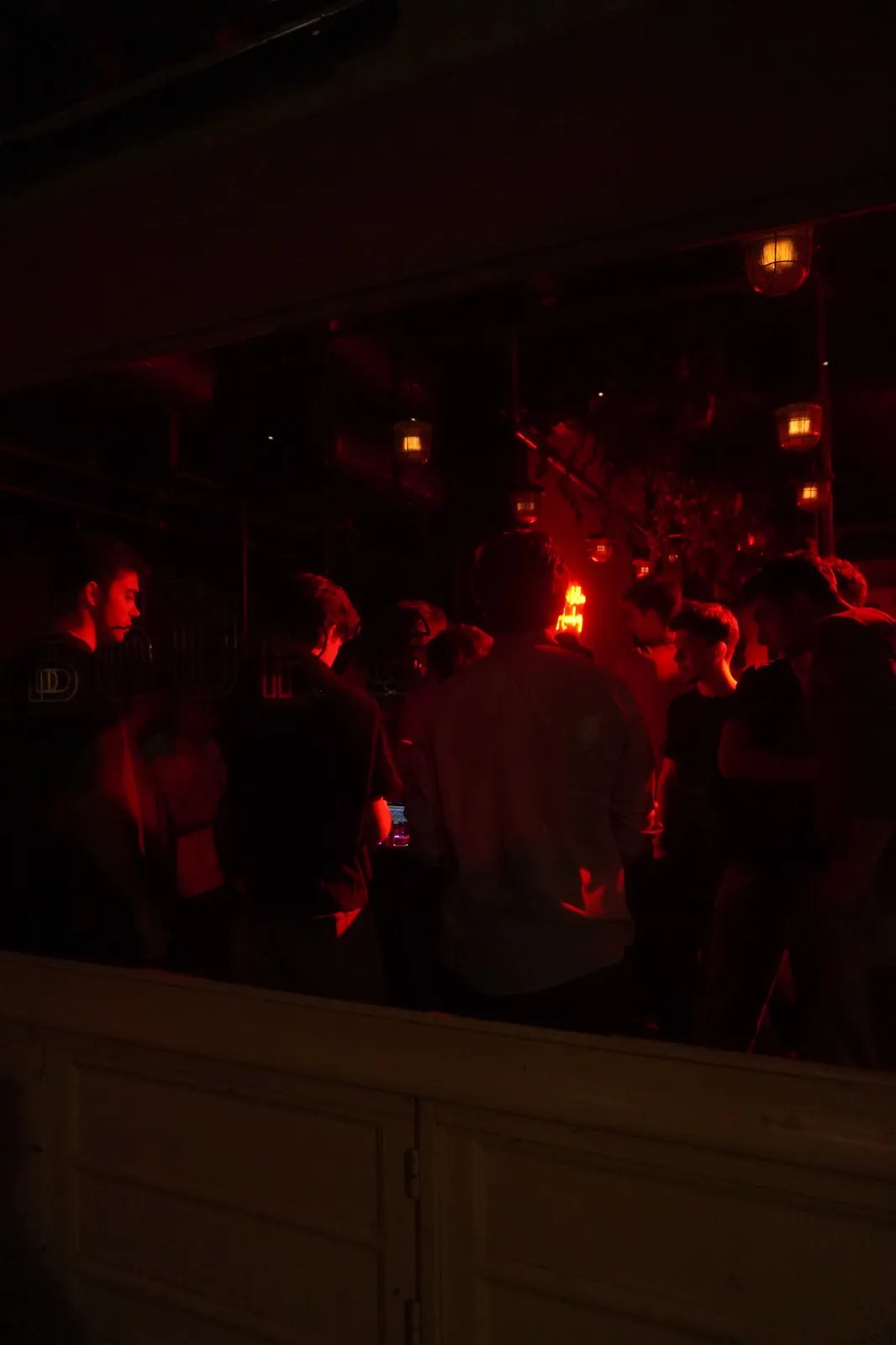 Guests standing around the DJ booth at DELETE:TUR