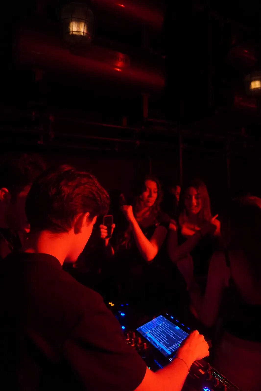 DJ set with guests dancing close by