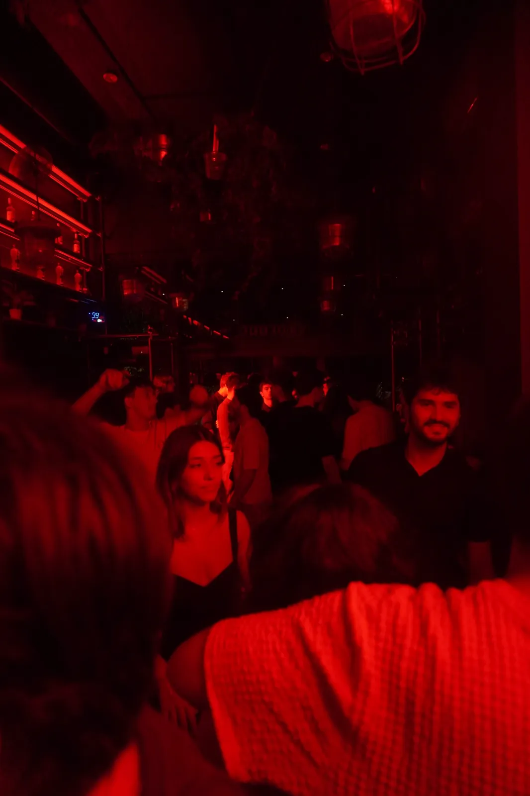 Crowd inside Café Luxembourg under red lights