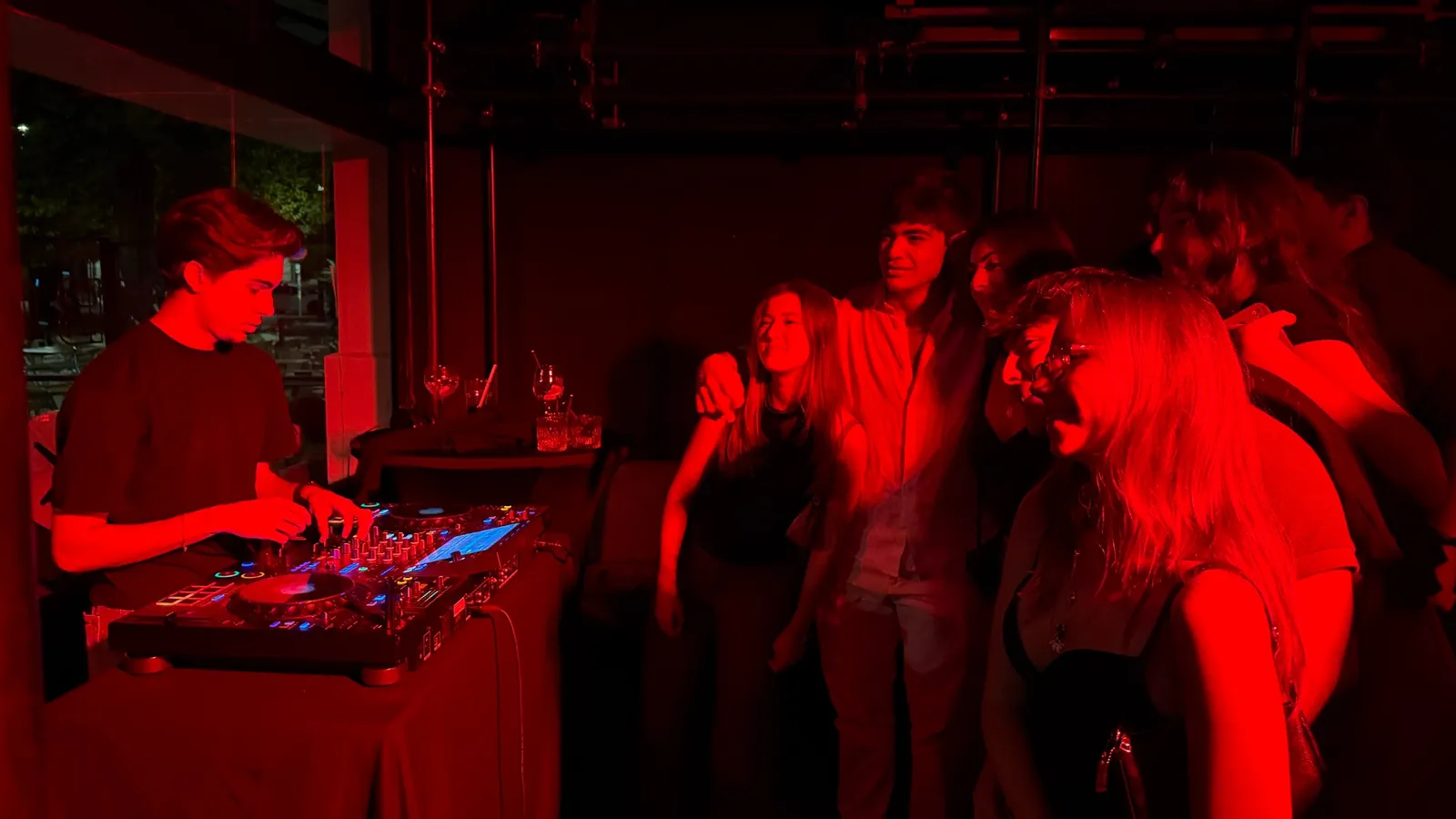 DJ playing for guests gathered nearby