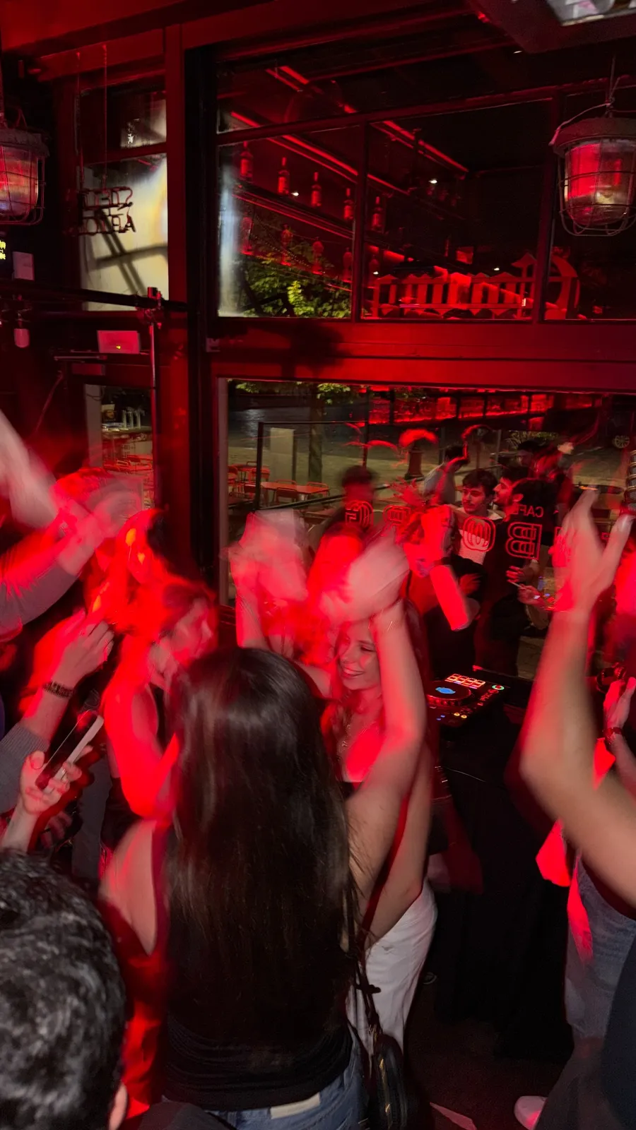 Crowd dancing under red light